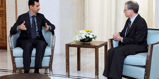 Jan. 27, 2011: Syrian President Bashar Assad, left, meets with Robert Ford, the U.S. ambassador to Syria, in Damascus, Syria.
