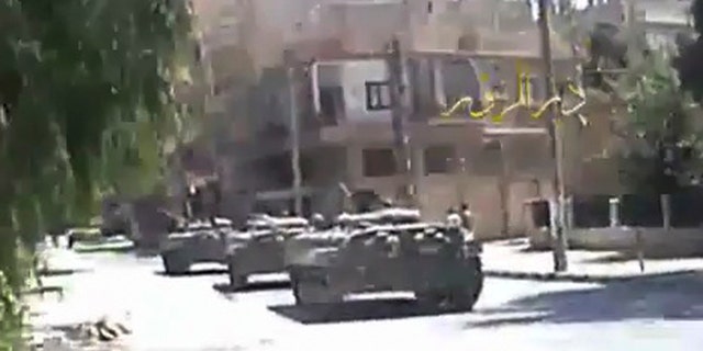 Aug. 10: In this image made from amateur video released by DPN (Deir el-Zour Press news) and accessed via The Associated Press Television News on Wednesday, shows Syria tanks on the street in Deir el-Zour, Syria on Tuesday Aug. 9. 2011. Syrian troops seized control of the eastern flashpoint city of Deir el-Zour Wednesday following intense shelling and gunfire, an activist said, as the international community intensified its pressure on the country's president to end the deadly crackdown.