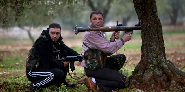 Feb. 27: Free Syrian Army fighters take positions as the Syrian Army advances towards the town of Sarmin, in northern Syria.