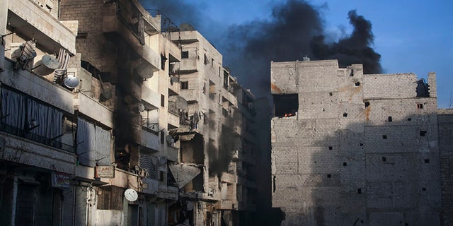 Dec. 5, 2012: Smoke rises from residential buildings due heavy fighting between Free Syrian Army fighters and government forces in Aleppo, Syria.