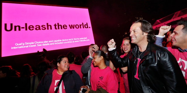 IN THIS IMAGE DISTRIBUTED BY AP IMAGES FOR T-MOBILE - T-Mobile CEO John Legere celebrates the end of international data roaming fees at a special event for customers with Shakira in New York's Bryant Park on Wednesday, Oct. 9, 2013. T-Mobile has extended unlimited data and texting to Simple Choice customers traveling in more than 100 countries. (Jason DeCrow/AP Images for T-Mobile)