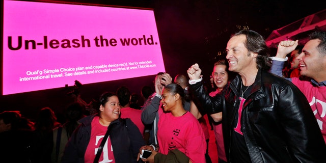 IN THIS IMAGE DISTRIBUTED BY AP IMAGES FOR T-MOBILE - T-Mobile CEO John Legere celebrates the end of international data roaming fees at a special event for customers with Shakira in New York's Bryant Park on Wednesday, Oct. 9, 2013. T-Mobile has extended unlimited data and texting to Simple Choice customers traveling in more than 100 countries. (Jason DeCrow/AP Images for T-Mobile)