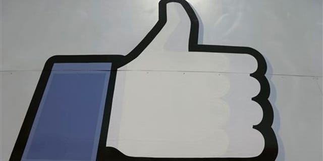 This June 11, 2014, photo shows Facebook's "like" symbol at the entrance to the company's campus in Menlo Park, Calif. (AP Photo/Jeff Chiu)