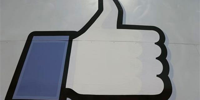 This June 11, 2014, photo shows Facebook's "like" symbol at the entrance to the company's campus in Menlo Park, Calif. (AP Photo/Jeff Chiu)