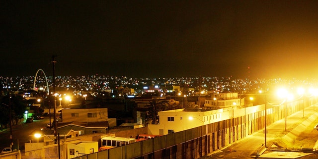 TIJUANA, MEXICO - MAY 04: The U.S.-Mexico border fence divides Tijuana (L) and the U.S. (R) in the early morning hours May 4, 2006 in Tijuana, Mexico. Mexican President Vicente Fox refused to sign a bill that would legalize the personal use of drugs and narcotics. The law would have been among the world's most permissive. On May 2, Fox's spokesman pledged the president would sign it but on May 3, hours after U.S. officials warned the plan could encourage "drug tourism?, the president sent the measure back to Congress for changes, prompting the Mexican media to accuse Fox of bowing to U.S. pressure. The law would have allowed possession of personal amounts of drugs by anyone 18 or older, including cocaine, Ecstasy, LSD, marijuana, heroin, opium, and more than 2 pounds of peyote, the hallucinogenic cactus used in native religious ceremonies. In the last 18 months, more than 1,000 people have been killed in escalating violence over smuggling routes to the U.S. Police and journalists have also become increasingly frequent targets, with automatic weapons and explosives becoming common tools of the trade. (Photo by David McNew/Getty Images)
