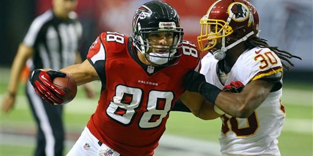 Atlanta Falcons tight end Tony Gonzalez (88) catches a pass against Washington Redskins cornerback E.J. Biggers during the second half of an NFL football game on Sunday, Dec. 15, 2013, in Atlanta. (AP Photo/Atlanta Journal-Constitution, Curtis Compton) MARIETTA DAILY OUT, GWINNETT DAILY POST OUT) LOCAL TV OUT (WXIA, WGCL, FOX 5)