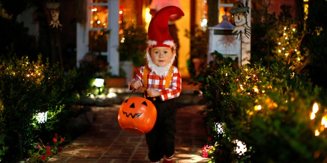 Oct. 31, 2012: A boy collects candy as he goes trick-or-treating for Halloween in Santa Monica, California.