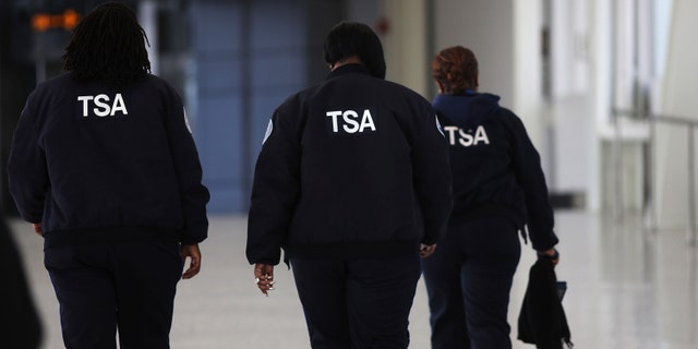 NEW YORK, NY - FEBRUARY 28: Transportation Security Administration (TSA) workers walk through John F. Kennedy Airport on February 28, 2013 in New York City. Should the $85 billion in automatic federal budget cuts, known as the sequester, go into effect Friday as scheduled, airport control towers in a number of states could close, putting pilots and staff members at risk. In addition to the closed control towers, TSA workers could be furloughed, leading to long waits and confusion at many airport security checkpoints. (Photo by Spencer Platt/Getty Images)