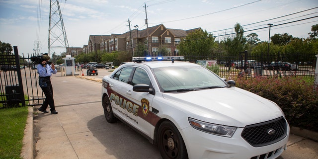 Authorities investigate a shooting at Texas Southern University, Friday, Oct. 9, 2015, in Houston. A student was killed and another person was wounded in a shooting outside a student-housing complex on Friday. (Cody Duty/Houston Chronicle via AP)