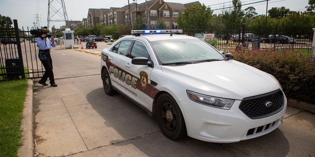 Authorities investigate a shooting at Texas Southern University, Friday, Oct. 9, 2015, in Houston. A student was killed and another person was wounded in a shooting outside a student-housing complex on Friday. (Cody Duty/Houston Chronicle via AP)