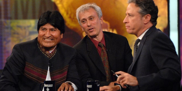 FILE - In this Sept. 25, 2007 file photo, Bolivian President Evo Morales, left, speaks with host Jon Stewart, right, as an interpreter looks on, during a taping of Comedy Central's "The Daily Show with Jon Stewart" in New York. Morales, a poor farmer, became the country's first indigenous president and assumed office in 2006. After more than 16 years and nearly 2,600 telecasts, Stewart will end his show on Aug. 6. (AP Photo/Peter Kramer, FIle)
