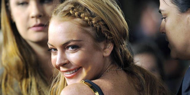 FILE - This April 11, 2013 file photo shows actress Lindsay Lohan, a cast member in "Scary Movie V," at the premiere of the film in Los Angeles. (Photo by Chris Pizzello/Invision/AP, File)