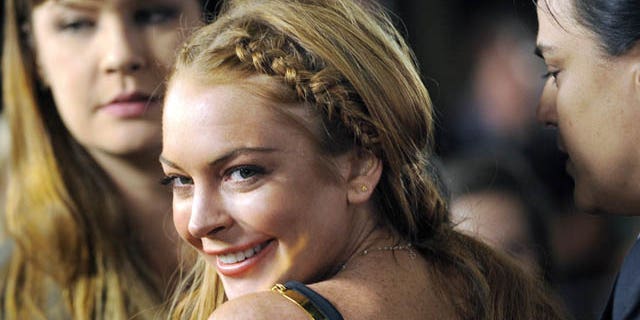 FILE - This April 11, 2013 file photo shows actress Lindsay Lohan, a cast member in "Scary Movie V," at the premiere of the film in Los Angeles. (Photo by Chris Pizzello/Invision/AP, File)