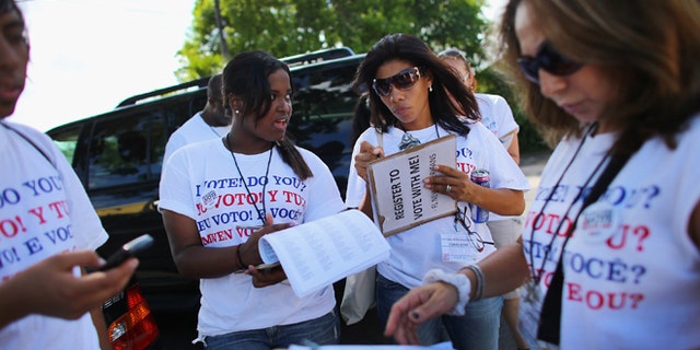 POMPANO BEACH, FL - OCTOBER 04: Mary Collante (L) and Zunilda Boone along with other members of the Florida Immigrant Coalition prepare to go door to door looking to sign up voters during a voter registration drive by on October 4, 2012 in Pompano Beach, Florida. Efforts to get people to register to vote for the upcoming presidential election ends on Tuesday the 9th when the voting rolls close in Florida. (Photo by Joe Raedle/Getty Images)