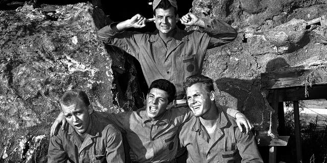 From l-r: Gary Crosby, Frankie Avalon and Tab Hunter harmonize while Jody McCrea holds his ears against the singing, Jan. 1963. All play members of a naval demolition team in the film "Bikini."