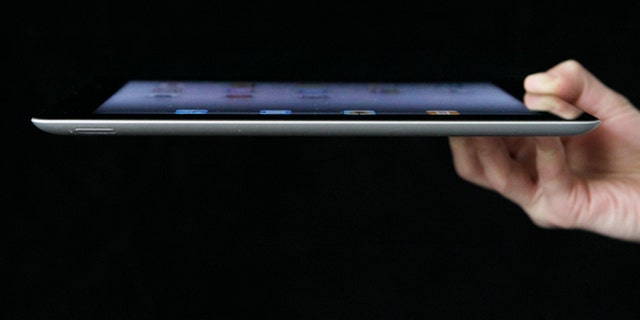 An Associated Press reporter demonstrates Apple's iPad 2 in San Francisco.