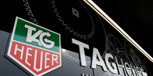 The Tag Heuer logo is seen at the entrance of their new watch manufactory in Chevenez November 5, 2013. Swiss watch brand TAG Heuer expects single-digit sales growth this year and is aiming to outperform market growth estimated at about 5 percent in 2014, its head told Reuters on Tuesday. REUTERS/Ruben Sprich (SWITZERLAND - Tags: BUSINESS) - RTX1517Z