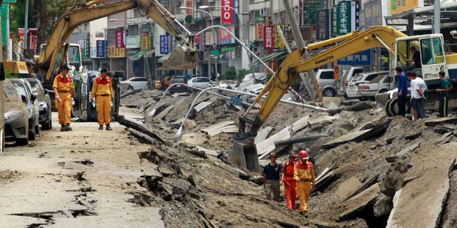 Aug. 1, 2014 - An emergency rescue team searches for missing persons believed to be buried after massive gas explosions in Kaohsiung, Taiwan.
