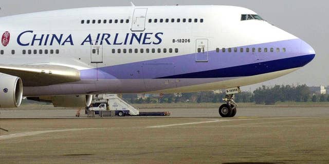 FILE - A China Airlines Boeing 747-400 sits on the tarmac at the Chiang Kai-shek International airport in Taoyuan, Taiwan.