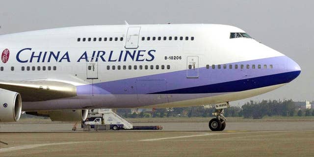 FILE - A China Airlines Boeing 747-400 sits on the tarmac at the Chiang Kai-shek International airport in Taoyuan, Taiwan.