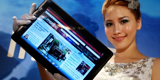 A model displays an AsusTek Eee Pad EP101TC tablet computer at an AsusTek new product media event on Monday, May 31, 2010, in Taipei, Taiwan. The 10-inch screen tablet, weighing 675 grams and measuring just 12.2 millimeters thick, is based on Windows and serves as a multimedia player, e-reader, compact PC and Internet device.