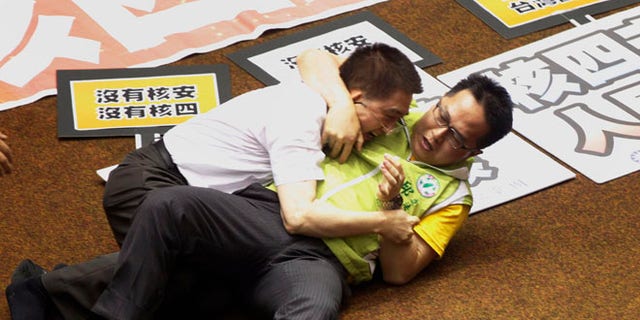 Aug 2, 2013: Ruling and opposition lawmakers fight each other on the legislature floor in Taipei, Taiwan.