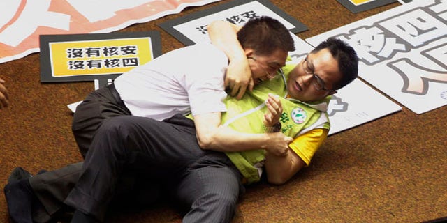 Aug 2, 2013: Ruling and opposition lawmakers fight each other on the legislature floor in Taipei, Taiwan.