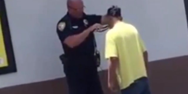 A Florida police officer went viral after being recorded helping a homeless man shave for a job interview at McDonald's.