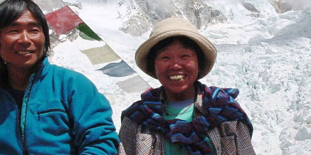 In this Thursday, May 9, 2002 file photo, Tamae Watanabe, right, of Japan poses with a photographer Noriyuki Muraguchi at a base camp on the foot of Mt. Everest in Nepal.