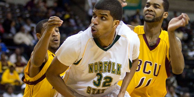 Norfolk State's Marcos Tamares (32) is guarded by Bethune-Cookman Kevin Dukes (21) and Javoris Bryant (11) during the first half of an NCAA college basketball game in the championship of the Mid-Eastern Athletic Conference tournament in Winston-Salem, NC., Saturday, March 10, 2012.