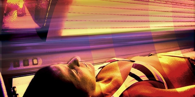Glenda Fuster lies in a tanning booth with full spectrum lighting at the head at Run to the Sun tanning salon in Anchorage, Alaska, Wednesday, Dec. 14, 2005, to help her cope with the dark winter days. While some Alaskans defy winter by embracing it, others cope by exposing themselves to bright-light therapy, billed by doctors as highly effective. Others install full-spectrum lighting in their homes and offices. Some people frequent tanning booths. Some take antidepressant medications. Some self-medicate with drugs or alcohol. (AP Photo/Al Grillo)