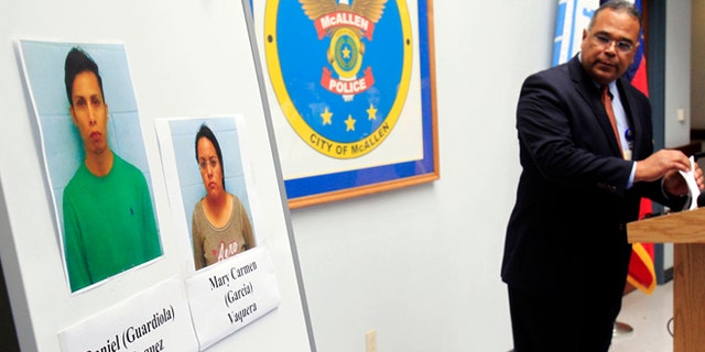 ADDS RECENT DEVELOPMENT- McAllen Police Chief Victor Rodriguez displays photos of Daniel Guardiola Dominiguez, left, and Mary Carmen Garcia, who were arrested Sunday after arriving at the border with 96 fraudulent credit cards that were produced using data stolen during the Target security breach late last year, Monday, Jan. 20, 2014, in McAllen, Texas. Rodriguez said Monday Jan. 20, 2014, that two Mexican citizens who were arrested at the border used account information stolen during the Target security breach to buy tens of thousands of dollars' worth of merchandise. But a federal official said later there currently was no connection between the arrests and the retailer's credit card data theft. (AP Photo/The Monitor, Gabe Hernandez) MAGS OUT; TV OUT (AP Photo/The Monitor, Gabe Hernandez) MAGS OUT; TV OUT