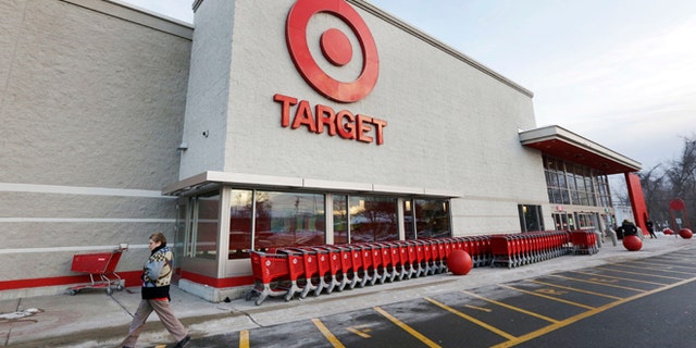 FILE - In this Dec. 19, 2013, file photo, a passer-by walks near an entrance to a Target retail store in Watertown, Mass. The security breach that hit Target Corp. during the crucial holiday season seemed to be part of a broader and highly sophisticated scam that affected several retailers, says a report published by a global cyber intelligence firm that works with the U.S. Secret Service and the Department of Homeland Security, Thursday, Jan. 16, 2014.  (AP Photo/Steven Senne, File)