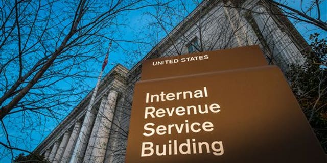 This photo taken April 13, 2014 shows the headquarters of the Internal Revenue Service (IRS) in Washington at daybreak. Tuesday, April 15, is the federal tax filing deadline for most Americans. (AP Photo/J. David Ake)