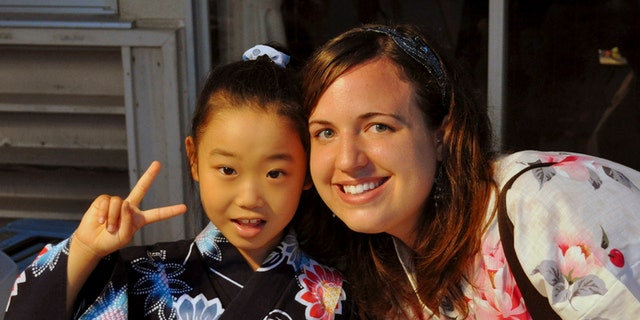 In this July 17, 2010 photo provided the Anderson family, Taylor Anderson, right, poses with one of her students in Ishinomaki, Japan.