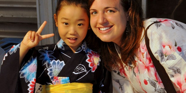In this July 17, 2010 photo provided the Anderson family, Taylor Anderson, right, poses with one of her students in Ishinomaki, Japan.