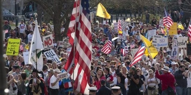 March 20: Tea Party demonstrators march outside of the House Chamber on Capitol Hill in Washington. (AP)