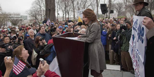 Rep. Michele Bachmann, R-Minn. addresses the Tea Party "Continuing Revolution Rally" on Capitol Hill in Washington, Thursday, March 31, 2011. (AP Photo/Evan Vucci)