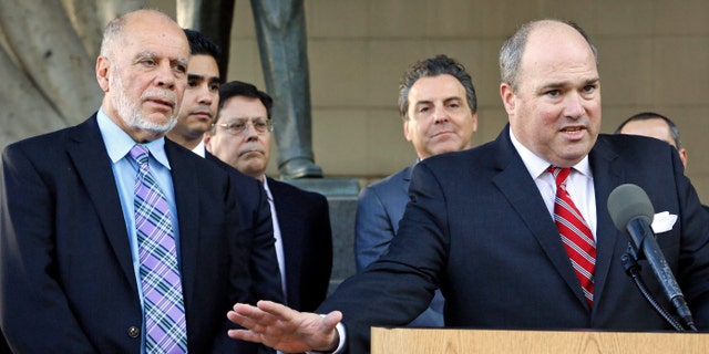 Nov. 21, 2014: Plaintiffs' attorney John Manly, right, with co-counsel Luis Carrillo, left, talks to reporters outside Los Angeles Superior Court