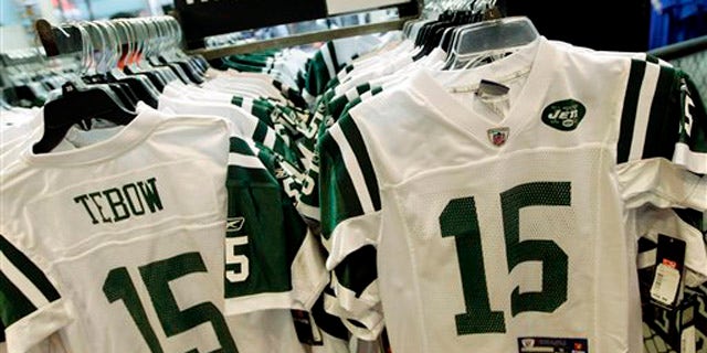 In this file photo, Reebok-branded New York Jets football jerseys with the name and number of Jets quarterback Tim Tebow are displayed at a Modell's store in New York.