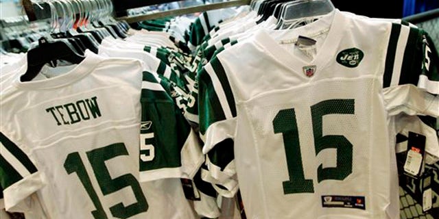 In this file photo, Reebok-branded New York Jets football jerseys with the name and number of Jets quarterback Tim Tebow are displayed at a Modell's store in New York.