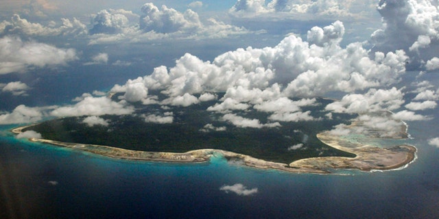 Clouds hang over the North Sentinel Island, in India's southeastern Andaman and Nicobar Islands. India used heat sensors on flights over hundreds of uninhabited Andaman Sea islands Friday, March 14, 2014, and will expand its search for the missing Malaysia Airlines jet farther west into the Bay of Bengal, officials said. The Indian-controlled archipelago that stretches south of Myanmar contains 572 islands covering an area of 720-by-52 kilometers. Only 37 are inhabited, with the rest covered in dense forests.