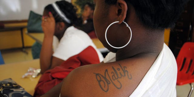 Shalendrick Tribble, 19, of in Marks, Miss., shows off a tattoo of her son's name in a classroom at Madison S. Palmer High School in Marks. (AP Photo/Laura Tillman)