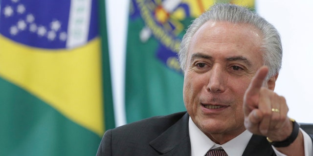 Brazil's acting President Michel Temer speaks during a meeting with trade unions, on the government's proposal for Social Security reform, at the Planalto Presidential Palace, in Brasilia, Brazil, Monday, May 16, 2016. Temer, Dilma Rousseff's two-time running-mate turned nemesis, immediately assumed power after her May 12 suspension and will remain while an impeachment trial takes place within the next six months. (AP Photo/Eraldo Peres)
