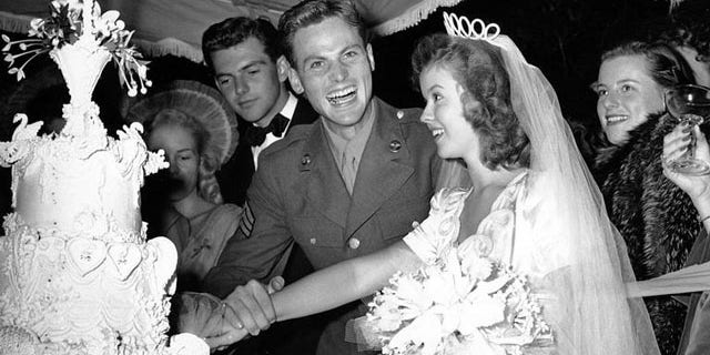 Shirley Temple with John Agar on their wedding day.