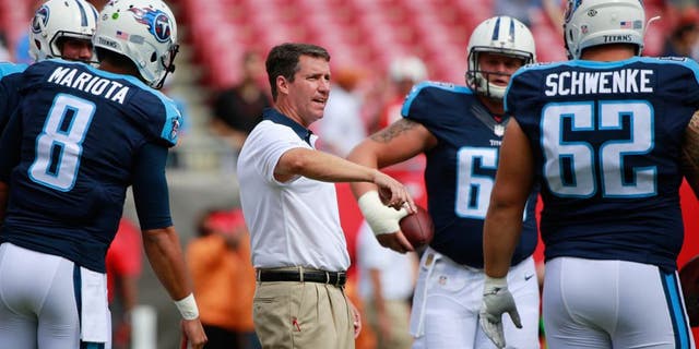 Sep 13, 2015; Tampa, FL, USA; Tennessee Titans quarterback coach John McNulty talks with center Brian Schwenke (62), quarterback Zach Mettenberger (7) and quarterback Marcus Mariota (8) prior to the game at Raymond James Stadium. Mandatory Credit: Kim Klement-USA TODAY Sports