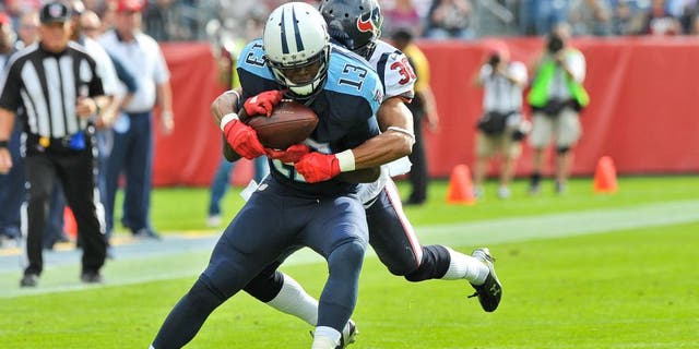 Dec 27, 2015; Nashville, TN, USA; Tennessee Titans wide receiver Kendall Wright (13) is tackled by Houston Texans strong safety Kevin Johnson (30) during the first half at Nissan Stadium. Mandatory Credit: Jim Brown-USA TODAY Sports