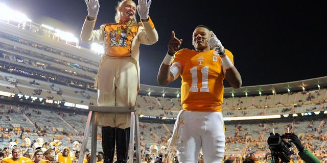 Nov 15, 2014; Knoxville, TN, USA; Tennessee Volunteers quarterback Joshua Dobbs (11) leads the band after the game against the Kentucky Wildcats at Neyland Stadium. Tennessee won 50 to 16. Mandatory Credit: Randy Sartin-USA TODAY Sports