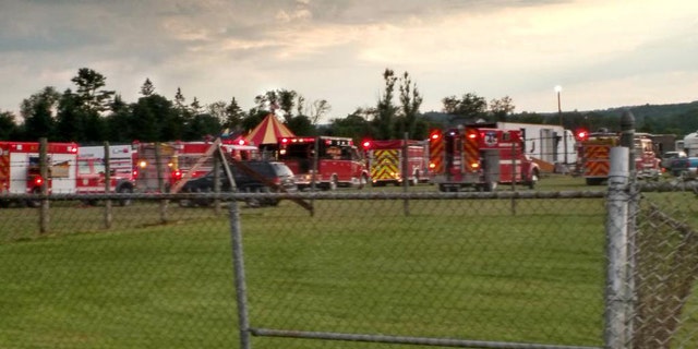 Officers surround the scene of a tent collapse in Lancaster, N.H., Monday, Aug. 3, 2015. Authorities say the circus tent collapsed when a severe storm raked the New Hampshire fairground. (Sebastian Fuentes via AP)