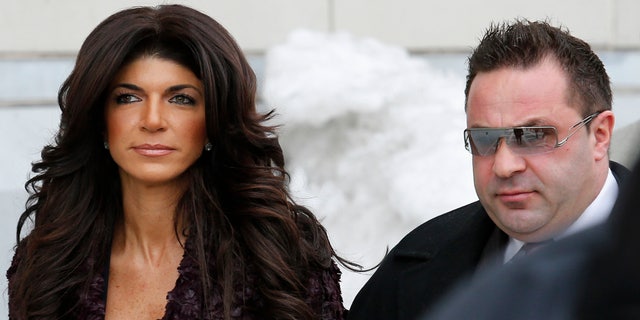 Teresa Giudice, 41, (L) and her husband Giuseppe "Joe" Giudice, 43, exit the Federal Court in Newark, New Jersey, March 4, 2014. REUTERS/Eduardo Munoz (UNITED STATES - Tags: CRIME LAW ENTERTAINMENT) - RTR3G1B9
